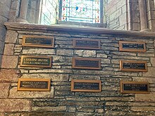 Memorial plaques for George Mackay Brown, Edwin Muir, John Mooney, Eric Linklater, Margaret Tait, J. Storer Clouston, Hugh Marwick, Robert Rendall, Stanley Cursiter in St Magnus Cathedral, Orkney