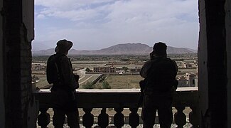 2002: Two US Special Forces soldiers view Kabul looking north