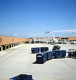 Ramp with baggage handling equipment and an America West jet (1989)