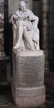A marble statue of Wilberforce, with an inscription beneath it
