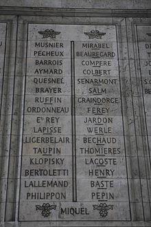 Photo shows two columns of French names etched in stone.