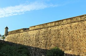 Large south curtain wall with bartizan and embrasures