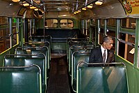 President Barack Obama sitting on the bus, in the same row on the opposite side from where Parks was arrested.