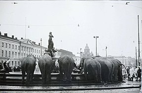 Elephants of the Swedish Circus Caravan drinking from the fountain in 1964