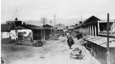 1882 view, looking north from Broad Place along Calle de los Negros to the Ignacio Del Valle adobe in the far background. At left, with the peeling paint, is the Coronel Adobe (SE corner of Arcadia). A few years later, both adobes would be demolished and Los Angeles St. would be extended northward to (and past) the Plaza.