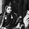 Black and white photograph of a seated woman in traditional Indian dress.