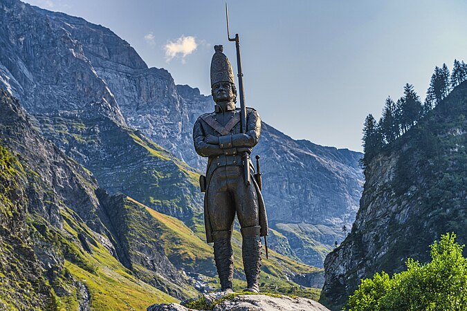 On the Panixer Pass way near Elm GL: a memorial was inaugurated on 6 October 2012 at the Wichlen Shooting Range in Glarus Süd to commemorate the Russian soldiers who marched through here with General Alexander Suvorov during the Second Coalition War. The sculpture of a grenadier was placed on a rock, and a memorial plaque with an inscription is attached to the rock.