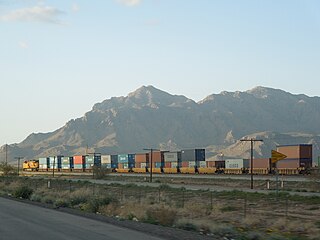 A train of well cars in Arizona carrying double-stacked containers
