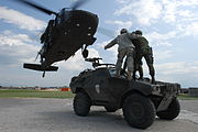 Portuguese soldiers hook their Panhard VBL to an UH-60 Blackhawk of the 224th Aviation Regiment.