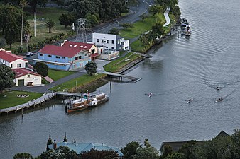 Looking down on the Whanganui River and the Paddle Steamer Waimarie, rowers and the Union Boat Club, from Durie Hill War Memorial Tower