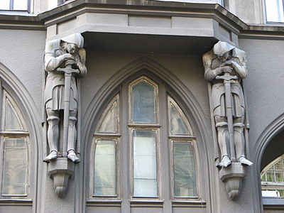 Gothic Revival atlantes on Kniazia Romana Street no. 6, Lviv, Ukraine, designed by Adolf Piller and Roman Volpel, 1913
