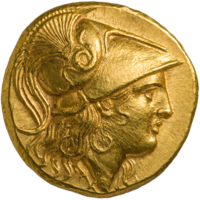 One side of a gold coin of Alexander the Great. The obverse, depicted, shows his profile in armor.