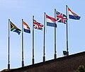 The six historical flags that have flown over the Cape, in chronological order from right to left: the Prince's Flag, the flag of Great Britain, the Batavian flag, the flag of the United Kingdom, the old South African flag, and the current South African flag