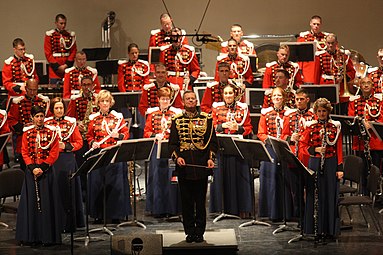 Colonel Colburn stands with the Marine Band after completing Sergei Rachmaninoff's Symphonic Dances during the Marine Band's performance at the East Carolina University in Greenville, North Carolina, 2011