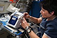 Samantha Cristoforetti demonstrating the first in-space operation of the rHEALTH ONE universal biomedical analyzer as part of Expedition 67