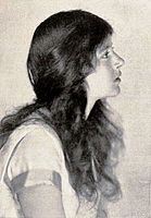 A photograph of actress June Walker in profile with long auburn hair.