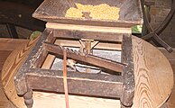 "Slipper" feeding corn into the grindstones of George Washington's Gristmill