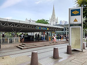 Photograph of the station entrance at ground level, with St Andrew's Cathedral in the background
