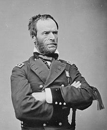 Black-and-white photograph of Sherman in uniform with his arms folded in front of him