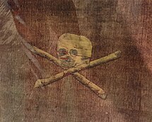 Red flag with with white skull and cross-bones