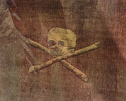 Red flag with with white skull and bones