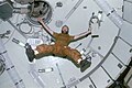 Carr floats with limbs outstretched to show the effects of zero-G.
