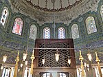 View of the tiled walls and the wooden throne above Mehmed's cenotaph