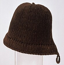 A brown hat with a rounded top and a carrying loop