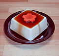 Japanese-style silken tofu with soy sauce and a decorative carrot slice