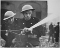 London firemen wearing Brodie-like steel helmets during World War II