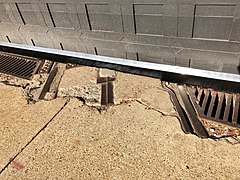 Streetcar tracks and conduit outside the garage's new east door (December 2018)
