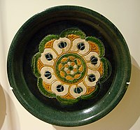 A rounded "offering plate" with design in "three colors" (sancai) glaze, 8th century