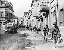 American Soldiers march through a German town in 1945