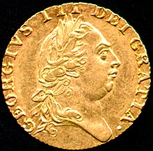 Gold coin bearing the profile of a round-headed George wearing a classical Roman-style haircut and a laurel wreath.