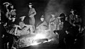 Members of the United States Army 16th Infantry Regiment gathered around a campfire in 1916 during the Pancho Villa Expedition