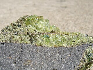 Peridot olivine with minor pyroxene, on vesicular basalt. (field of view = 35 mm)