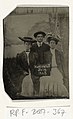 Portrait of a man and two women holding a signboard reading "Huntington Fair 1905"