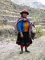 Quechua woman in Peru wearing a loaded aguayo