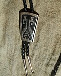 Silver overlay bolo tie, by Tommy Singer (Navajo)