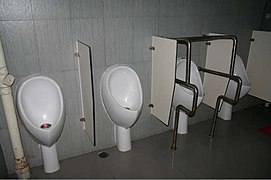 Waterless urinal (waterless urinal at right is for people with disabilities)