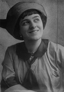 Black-and-white portrait of Fay King in a hat and smiling.
