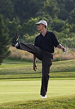 President Barack Obama puts a little body English on his shot during a round of golf at Farm Neck golf course during his vacation on Martha's Vineyard