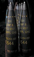 M107 projectiles. All are labelled to indicate a filling of "Comp B" and have fuzes fitted.