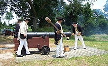 NPS photo shows an 18-pound cannon being "loaded" by American Revolutionary War re-enactors in a demonstration at Yorktown National Park, Virginia, USA.