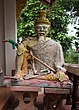 A statue of a hermit with an offering of betel quid from Thailand