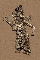 Goddess Ishtar/Inanna. She wears a long, flounced dress, a hat decorated with horns and a headed collar. She is extending a ring in her right hand and has club-like weapons in her back.[1]