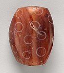 Indus Civilisation Carnelian bead with white design, c. 2900–2350 BC. Found in Nippur, Mesopotamian.[24]