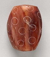 Indus Civilisation Carnelian bead with white design, ca. 2900–2350 BCE. Found in Nippur, Mesopotamian.[86]