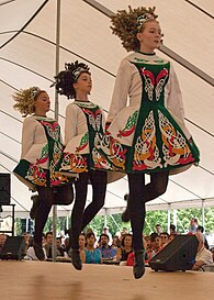 Folk dance – a trio of Irish Stepdancers performing in competition