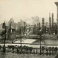 Smoke is still rising from the ruins of Richmond, Virginia after surrendering on April 3, 1865, following the Union victory at the siege of Petersburg. Union cavalry mounts with carbines visible are hitched in the foreground.